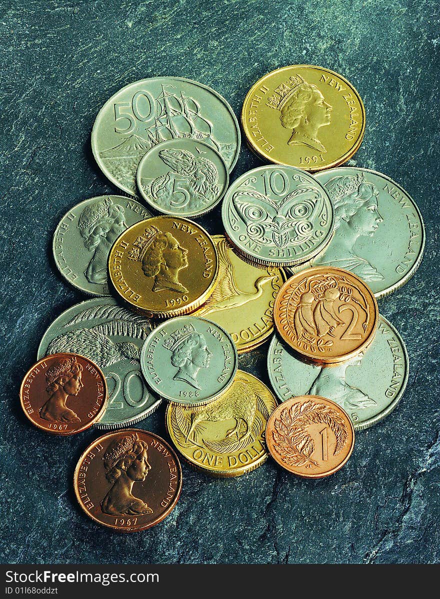 A heap of colorful coins on stone background