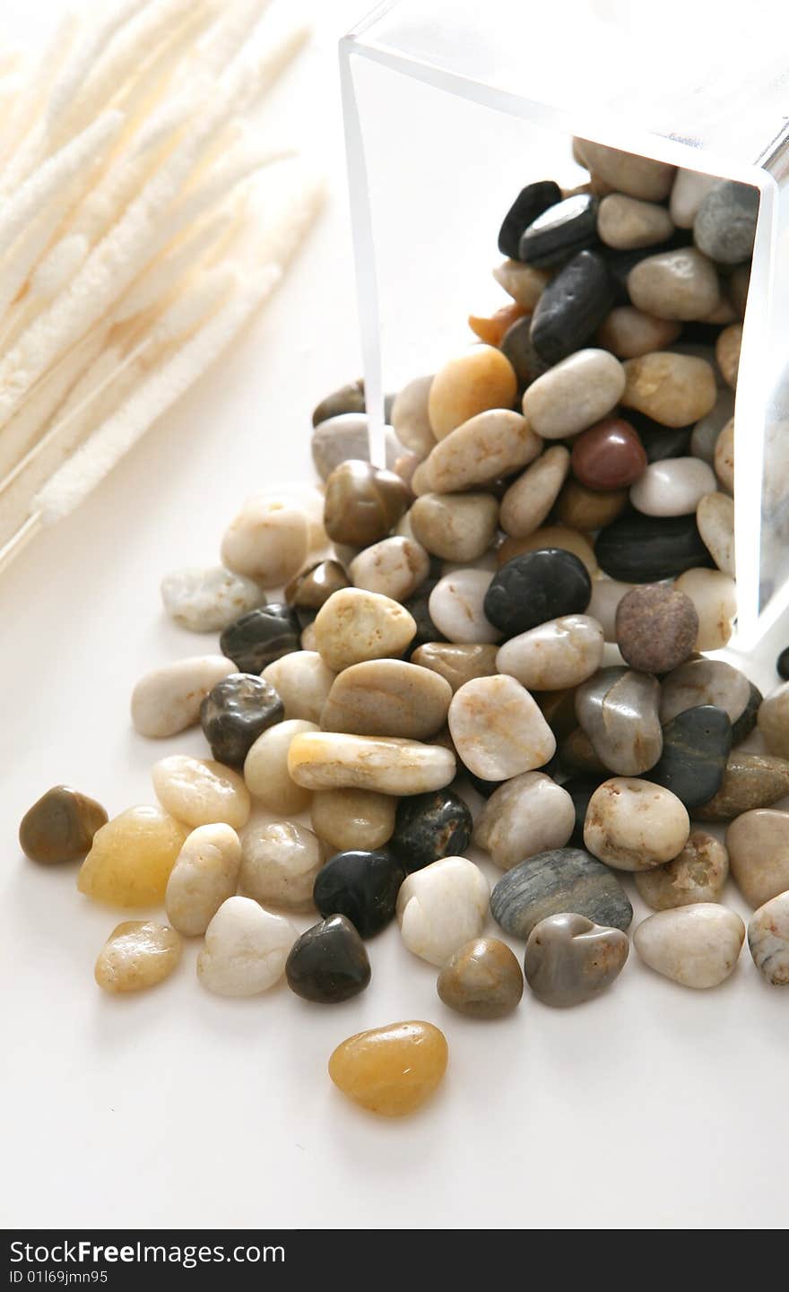 Colorful stones on white plate