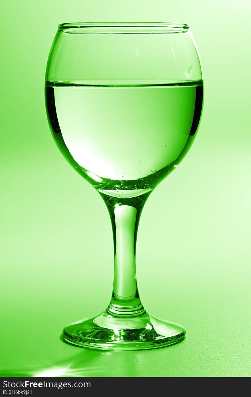 Beautiful wine glass with water toning in green. Beautiful wine glass with water toning in green