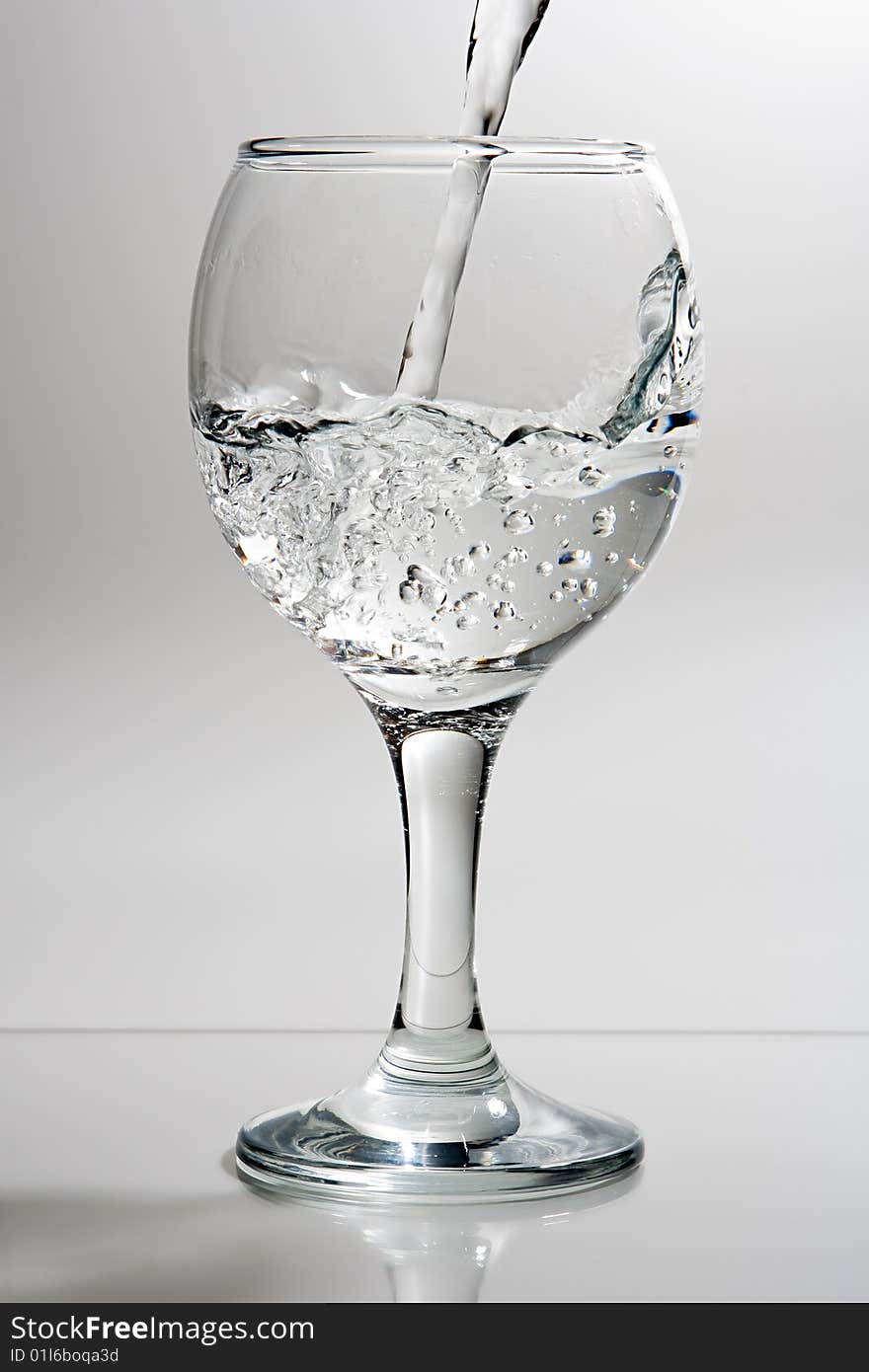 Wine glass with poured water. Wine glass with poured water