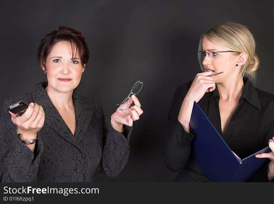 Composed Businesswomen holding a blue file against a black background. Composed Businesswomen holding a blue file against a black background