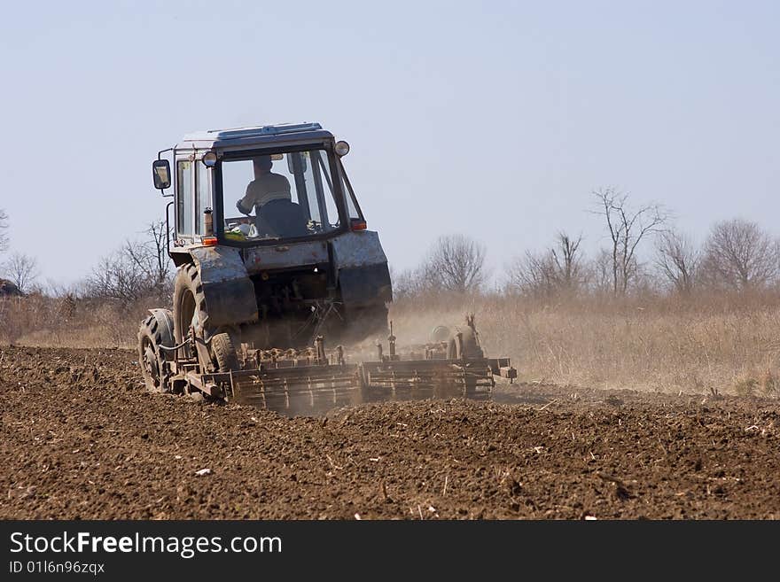 A tractor sowing seed in the field