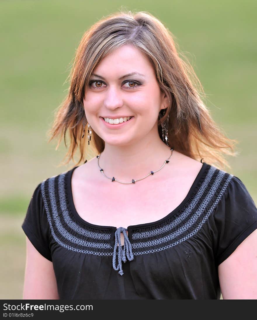 Outdoor portrait of a brunette woman with big brown eyes. Outdoor portrait of a brunette woman with big brown eyes