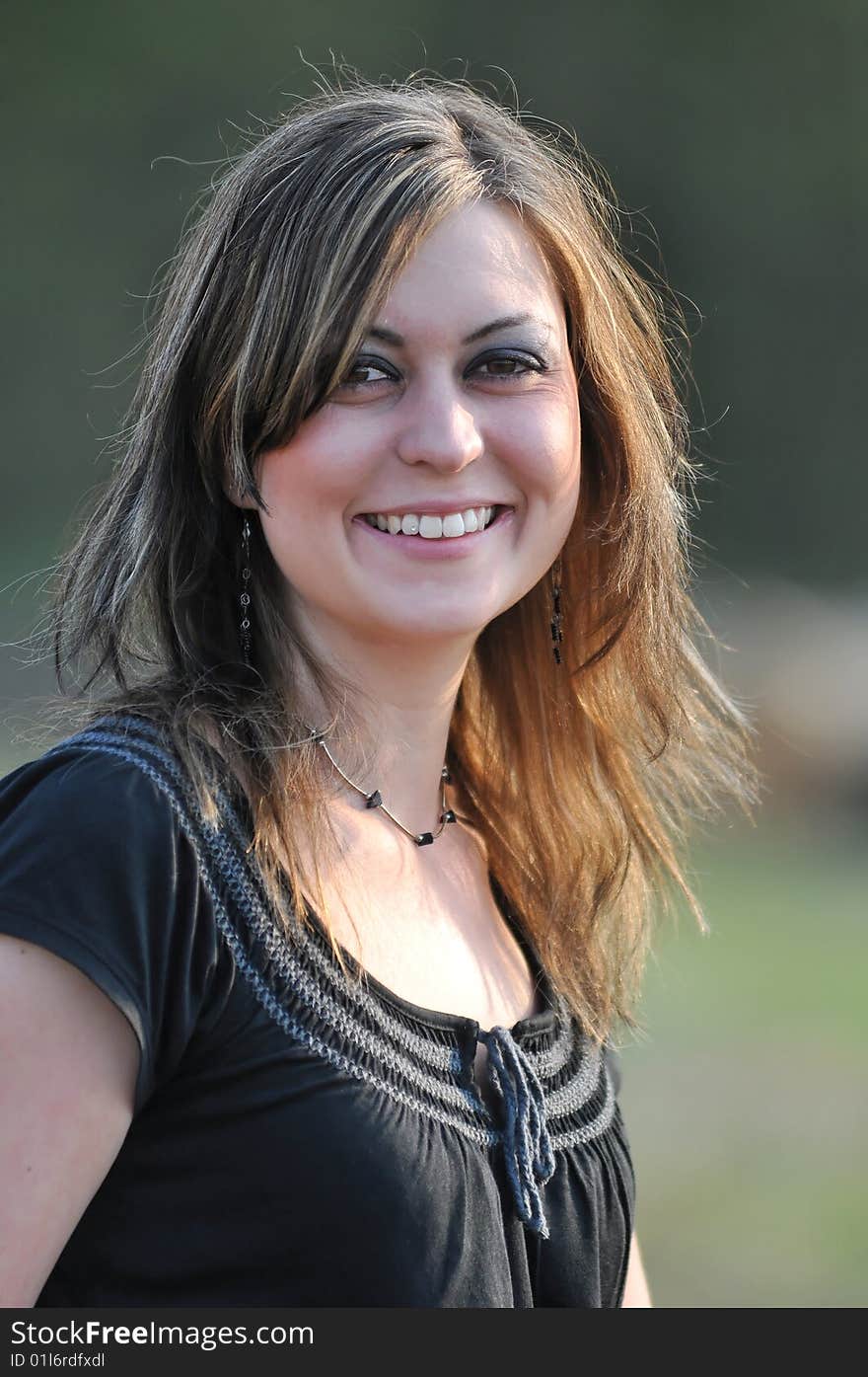 Outdoor portrait of a brunette woman with big brown eyes. Outdoor portrait of a brunette woman with big brown eyes