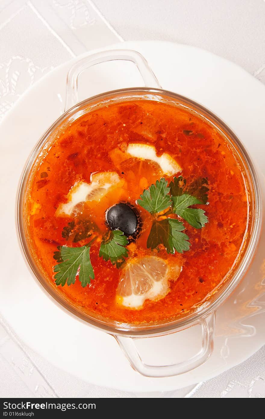 Tasty red soup with lemon over white