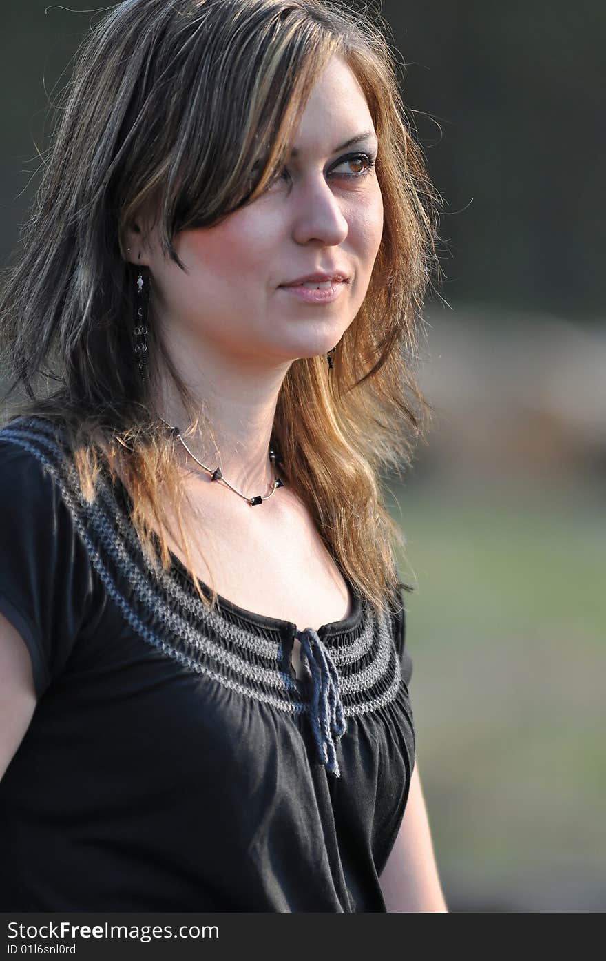 Outdoor portrait of a brunette woman with big brown eyes. Outdoor portrait of a brunette woman with big brown eyes