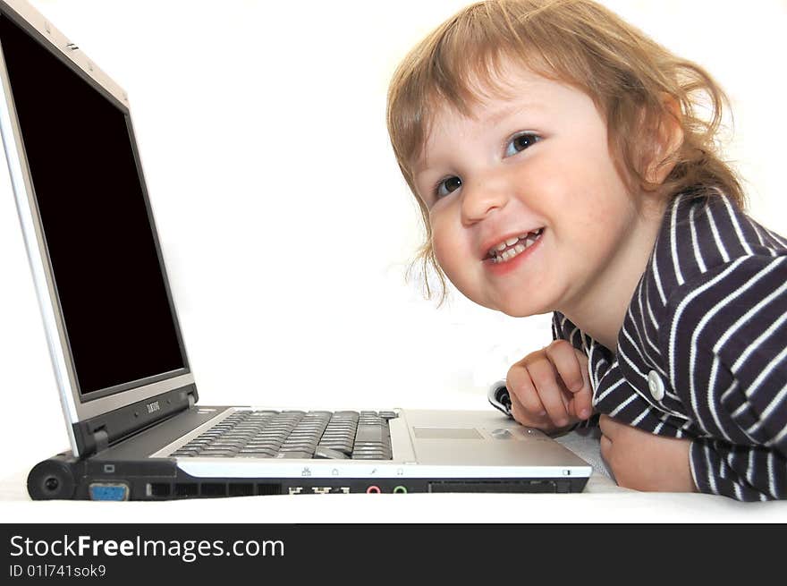 Baby girl working on laptop isolated white. Baby girl working on laptop isolated white