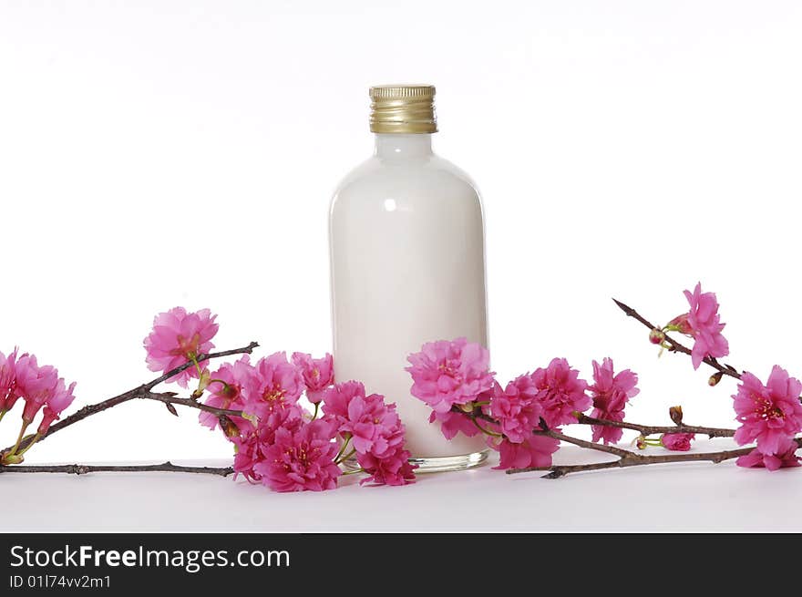 A bottle of massage oil with red flower. A bottle of massage oil with red flower