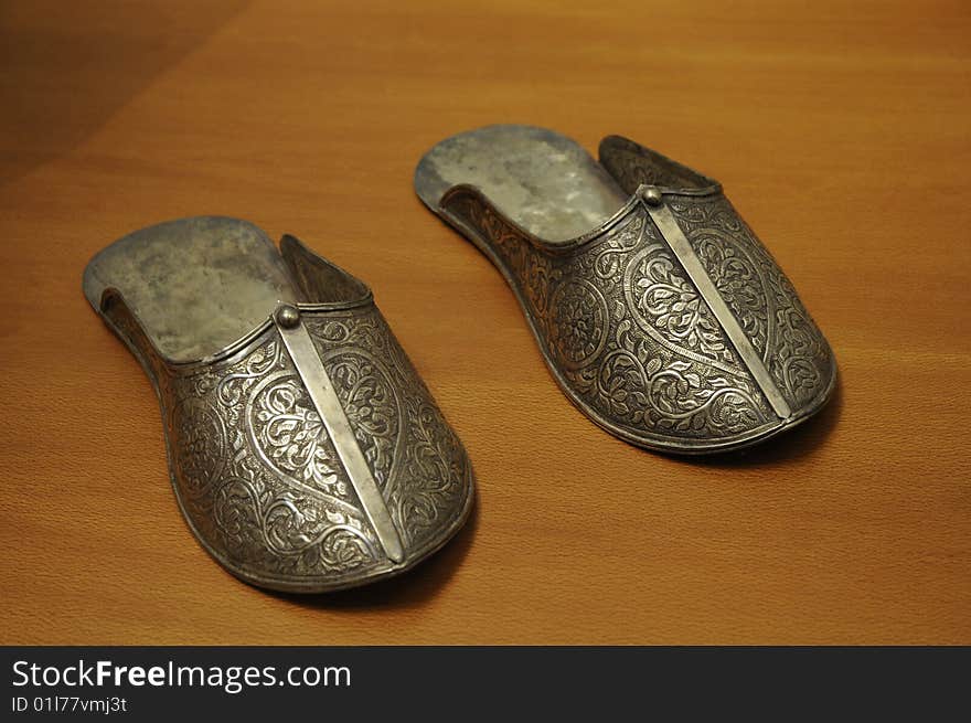 Golden shoes with beautiful decoration, ancient shoes artwork