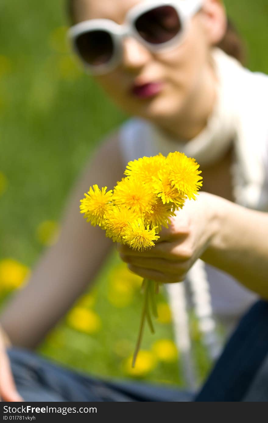 Young Woman In Nature Offering Flowers