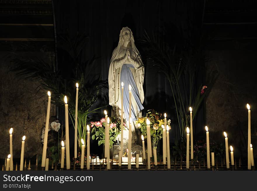 Statues of saint marie with candle light