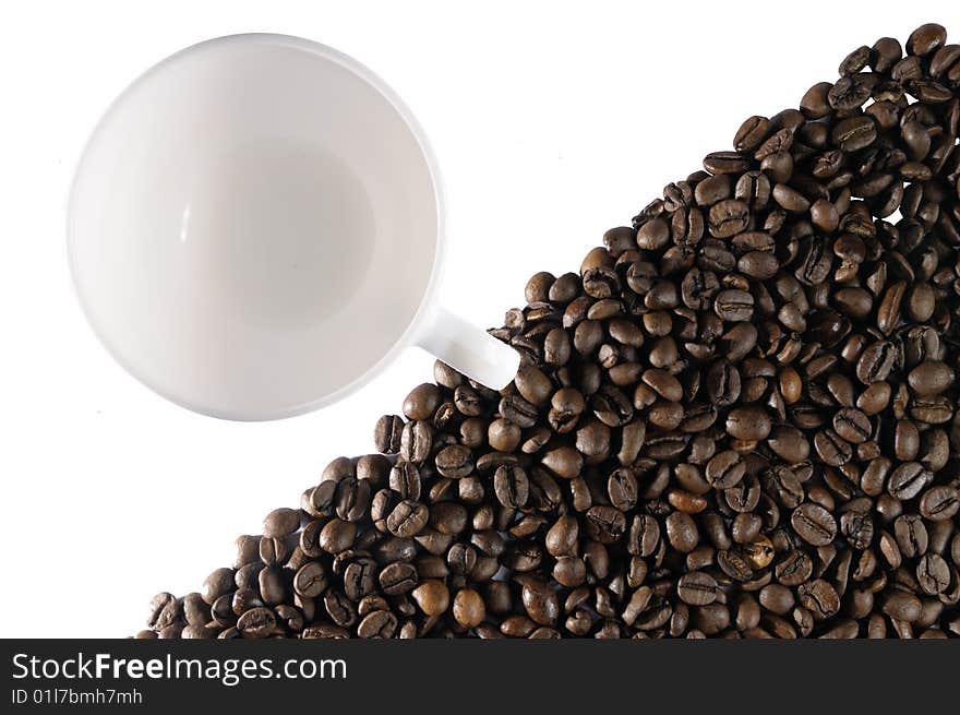 Coffee beans and a cup isolated on white background. Coffee beans and a cup isolated on white background