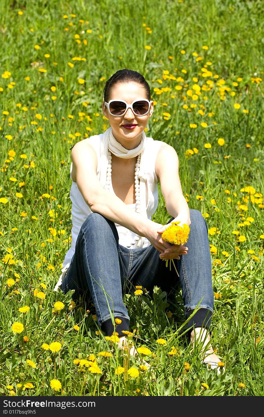 Young woman in nature holding flowers