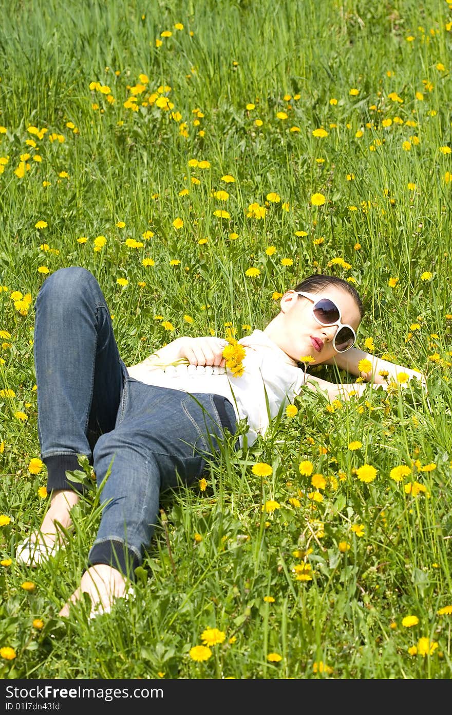 Young woman relaxing in nature holding flowers