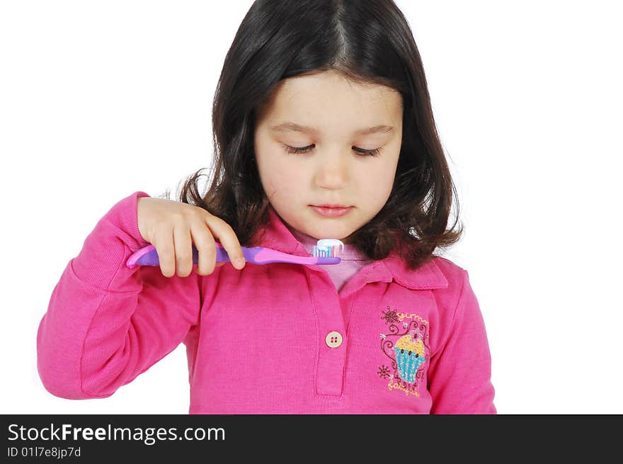 A little cute girl brushing the teeth isolated on white background