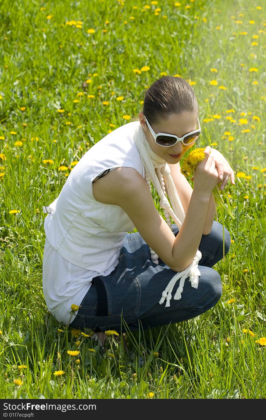 Young woman relaxing in nature holding flowers