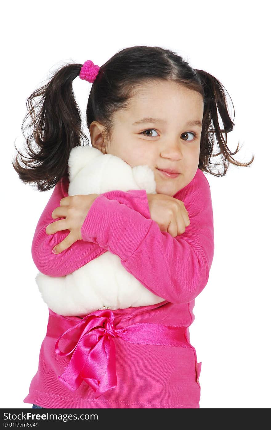 A little girl hugging a teddy bear isolated on white background