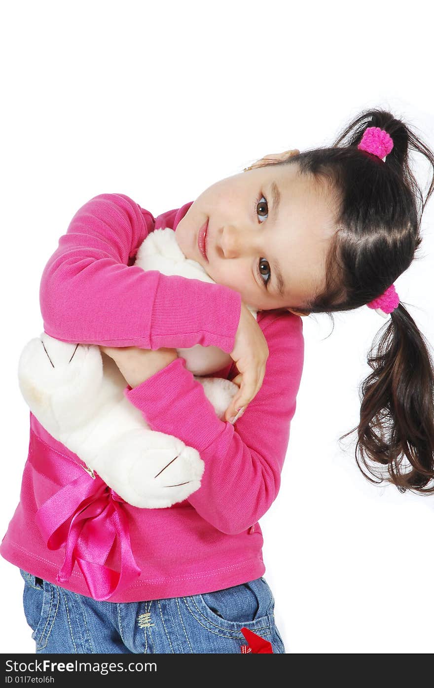 A little girl hugging a teddy bear isolated on white background