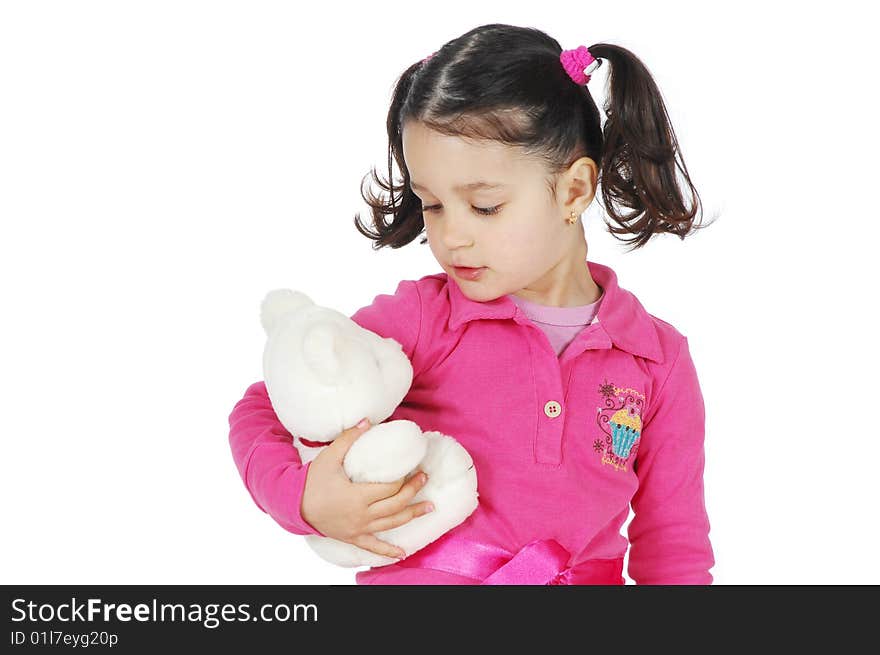 A little girl hugging a teddy bear isolated on white background