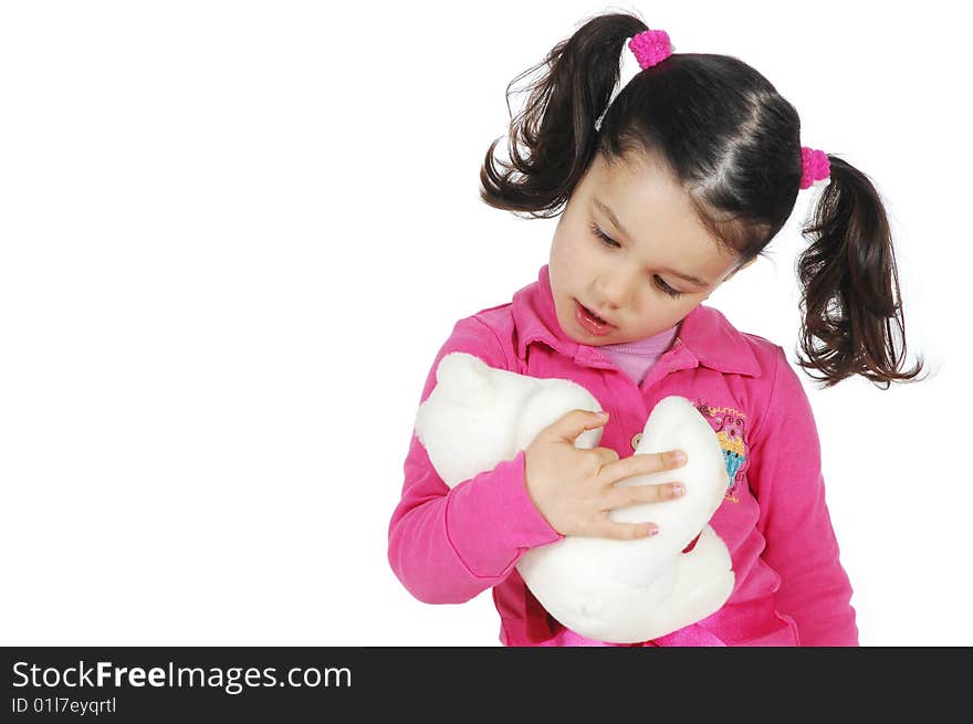 Little girl hugging a teddy bear