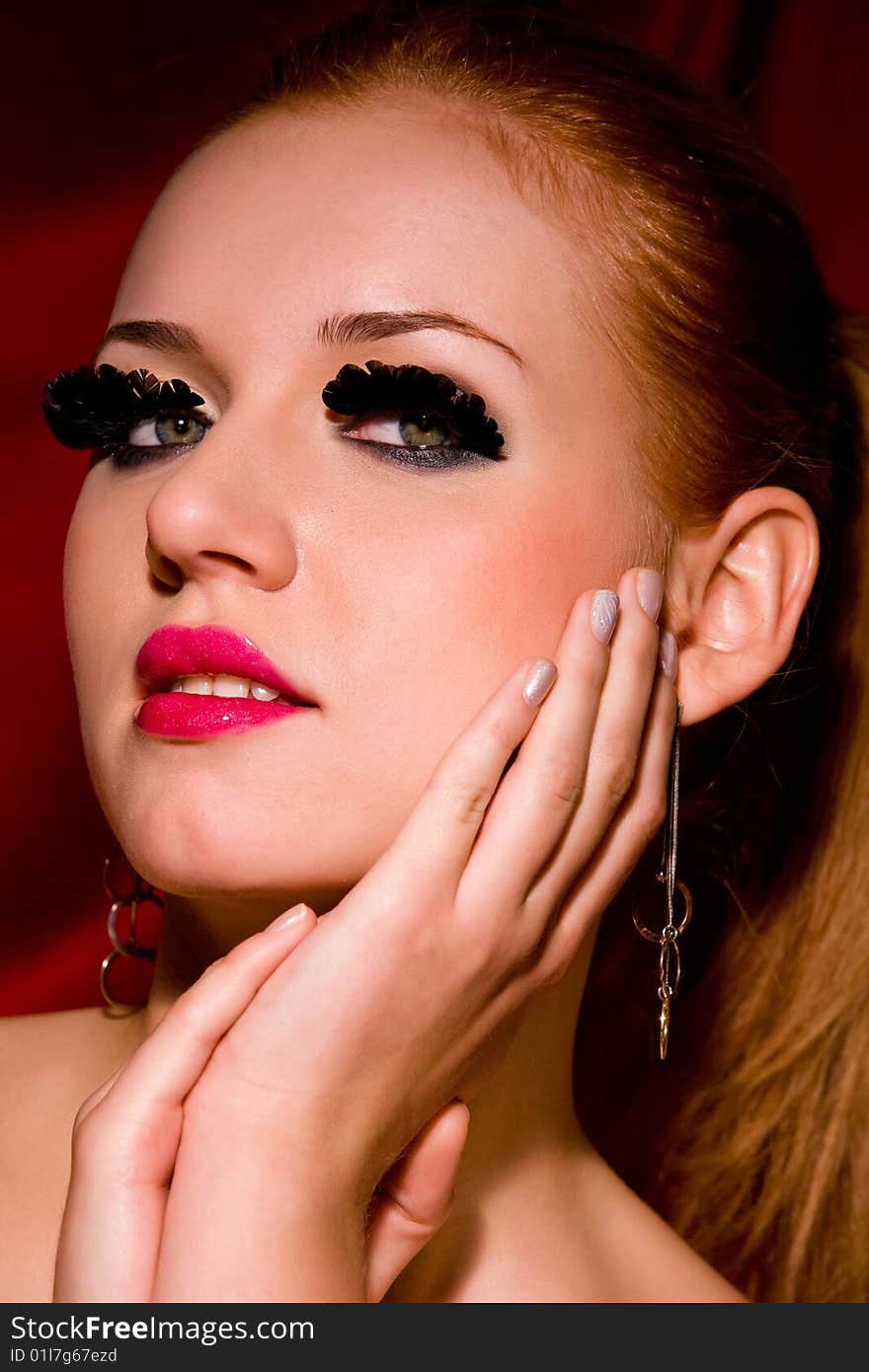 Glamour portrait of lovely blond young woman with big eyelashes