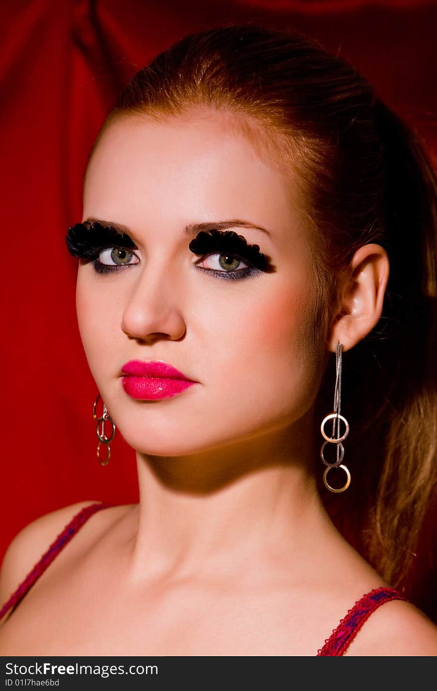 Glamour portrait of lovely blond young woman with big eyelashes