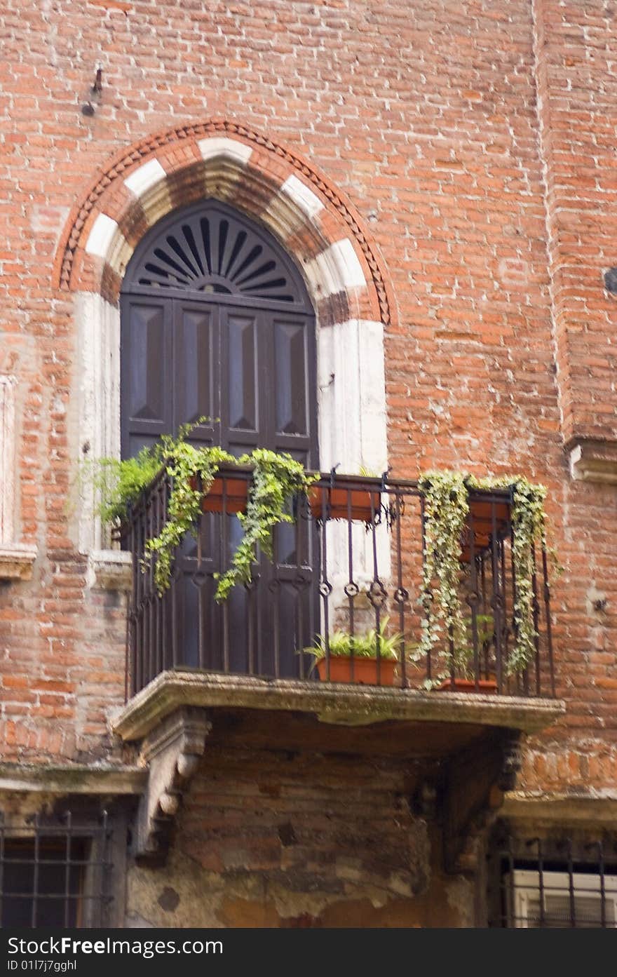 Balcony with door in ancient brick building in Verona Italy. Balcony with door in ancient brick building in Verona Italy