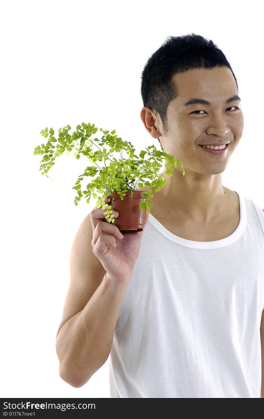 Young man holding up a green leaf. Young man holding up a green leaf