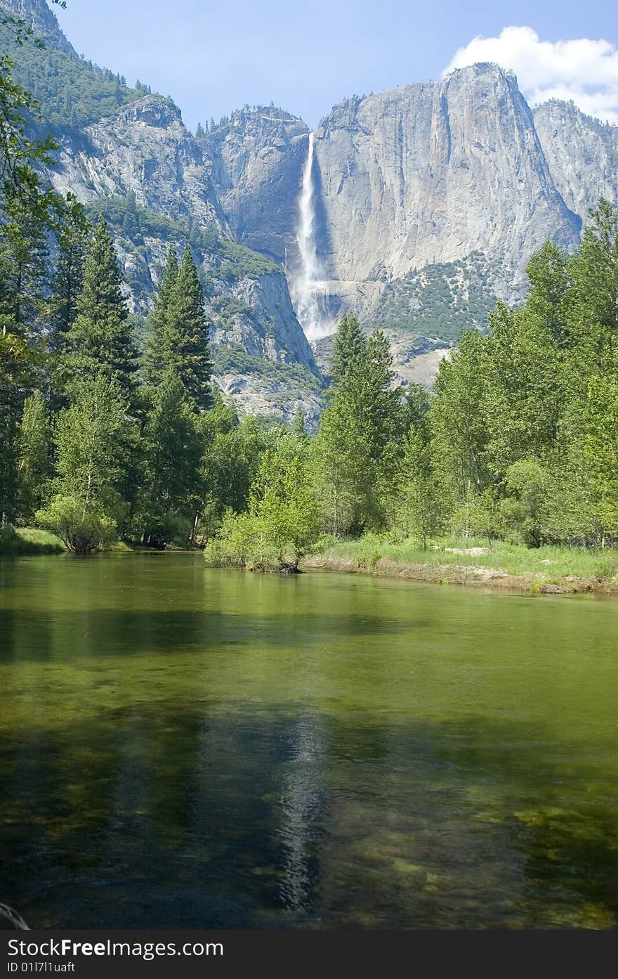 Yosemite Falls in the California Sierras reflected in the Merced river