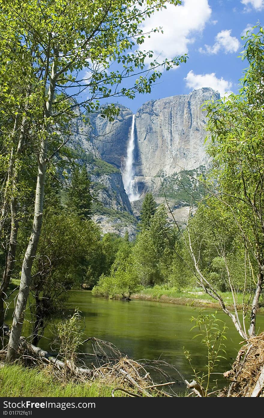 Yosemite Falls in the California Sierras reflected in the Merced river