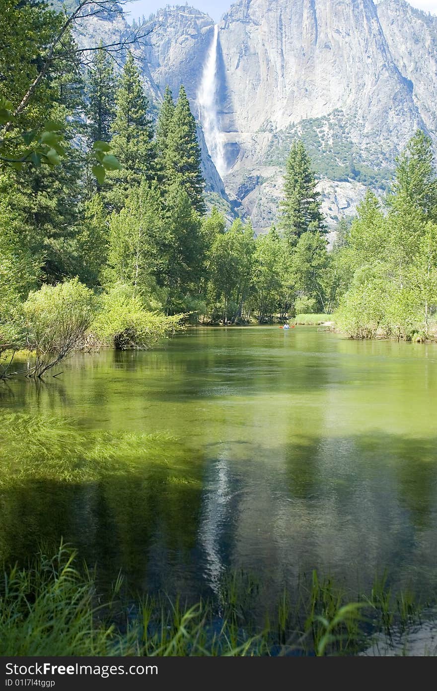 Yosemite Falls in the California Sierras reflected in the Merced river