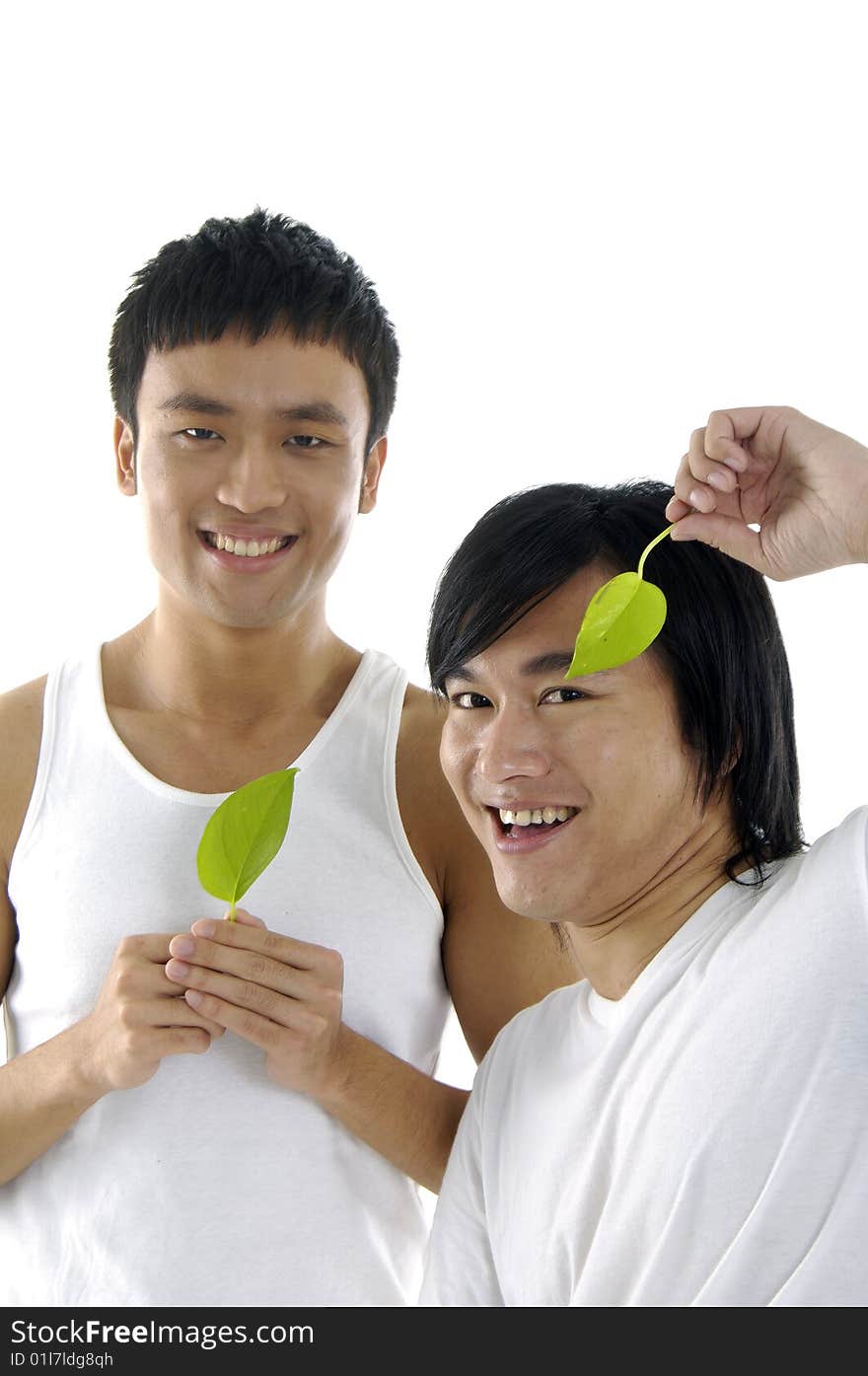 Couple young man holding up a green leaf. Couple young man holding up a green leaf