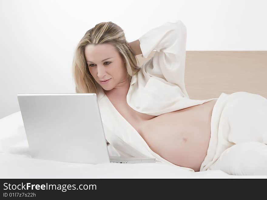 Pregnant woman working on a laptop