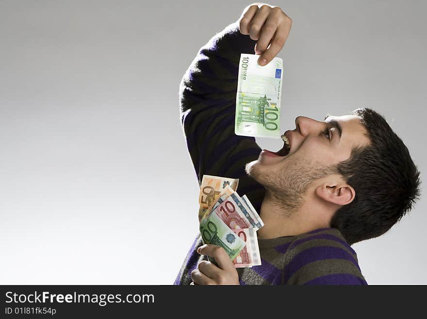 Happy businessman with bundle of euro money