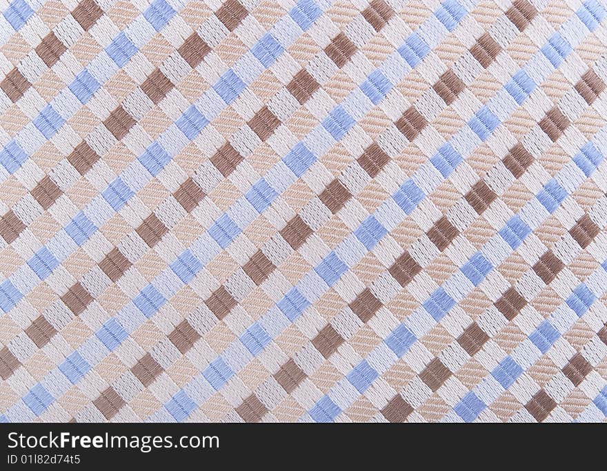 Textile background with blue, brown and beige shapes