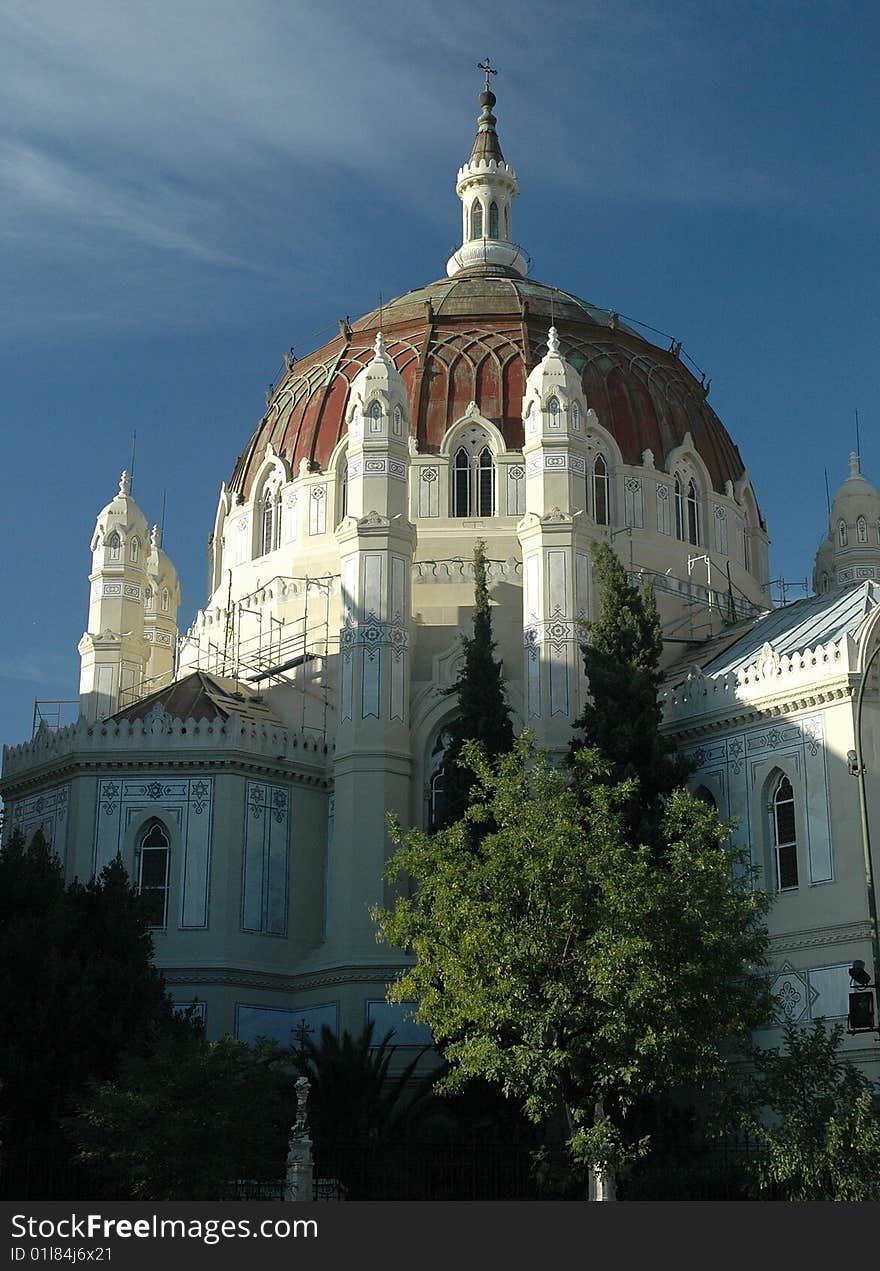 Ornate White church dome set against blue sky background. Ornate White church dome set against blue sky background