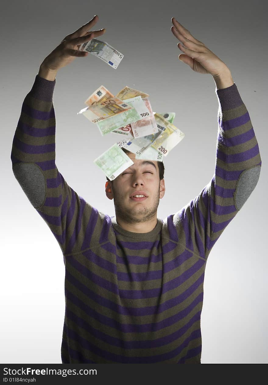 Happy businessman with bundle of euro money