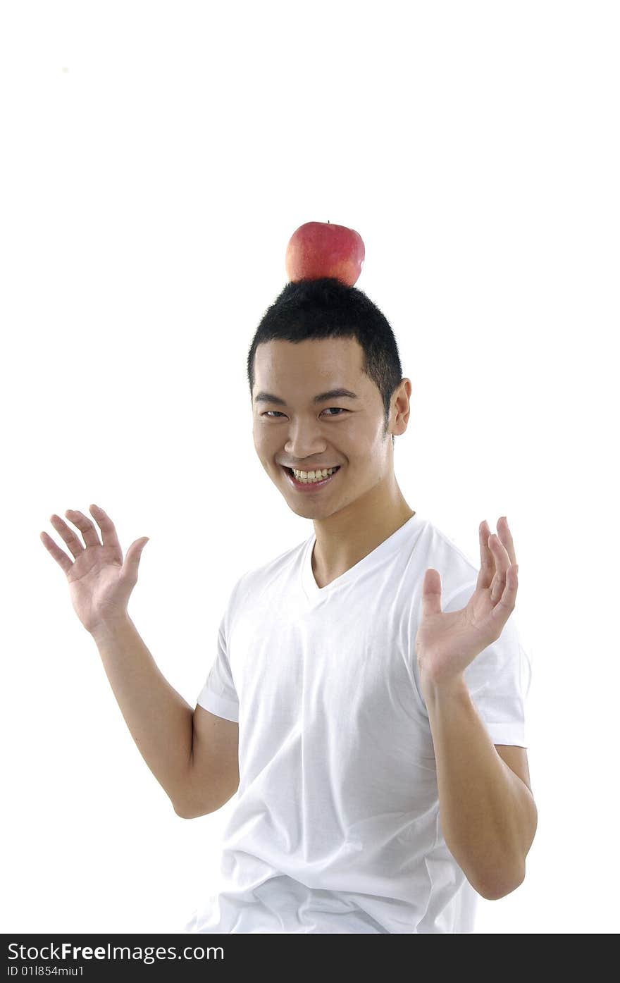 Funny young man having apple on his head. Funny young man having apple on his head