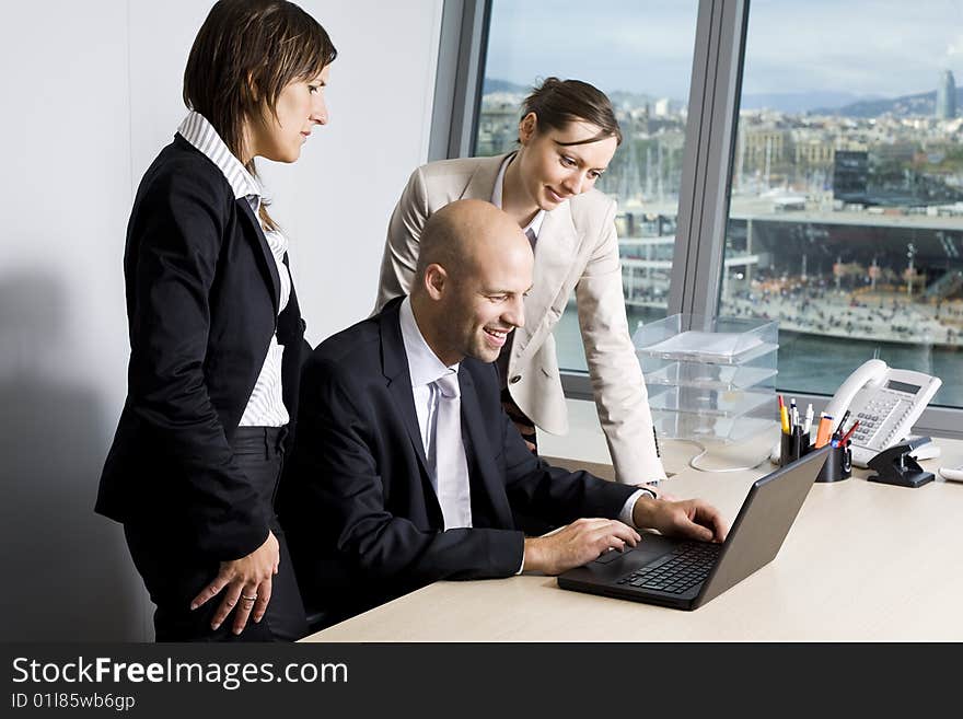 Young businessteam of three persons in office