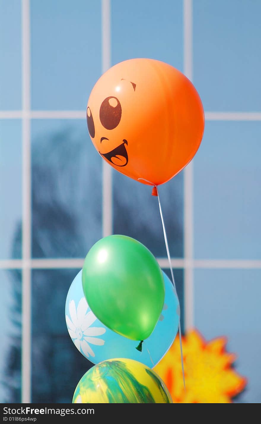 Colorful smiling ballons with the building background. Colorful smiling ballons with the building background