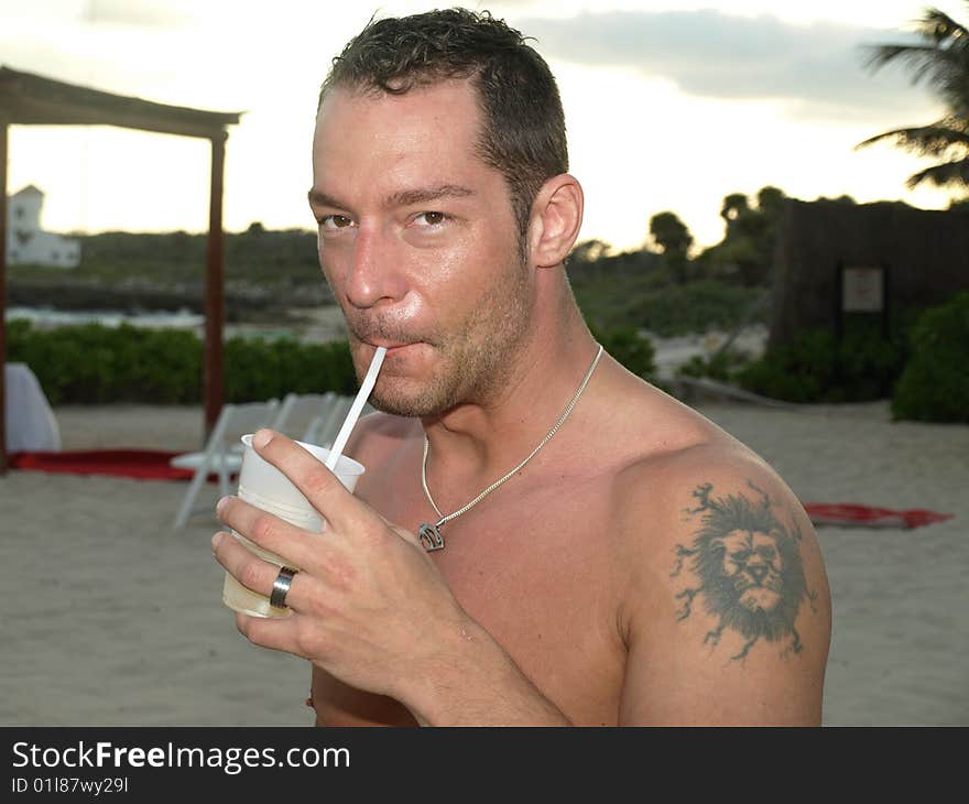 Young man quenching his thirst the hot climate at this mexican resort can take its toll. Young man quenching his thirst the hot climate at this mexican resort can take its toll.