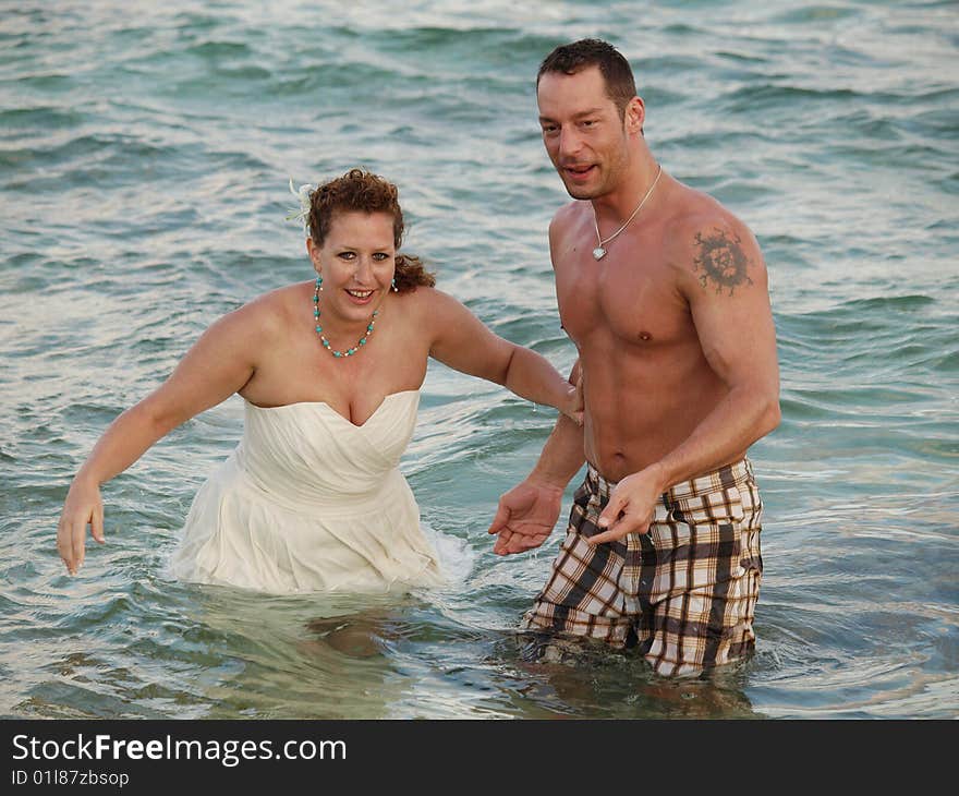 This young couple decided to initiate their wedding by taking a dip in the ocean either that or the groom cought a mermaid. This young couple decided to initiate their wedding by taking a dip in the ocean either that or the groom cought a mermaid.