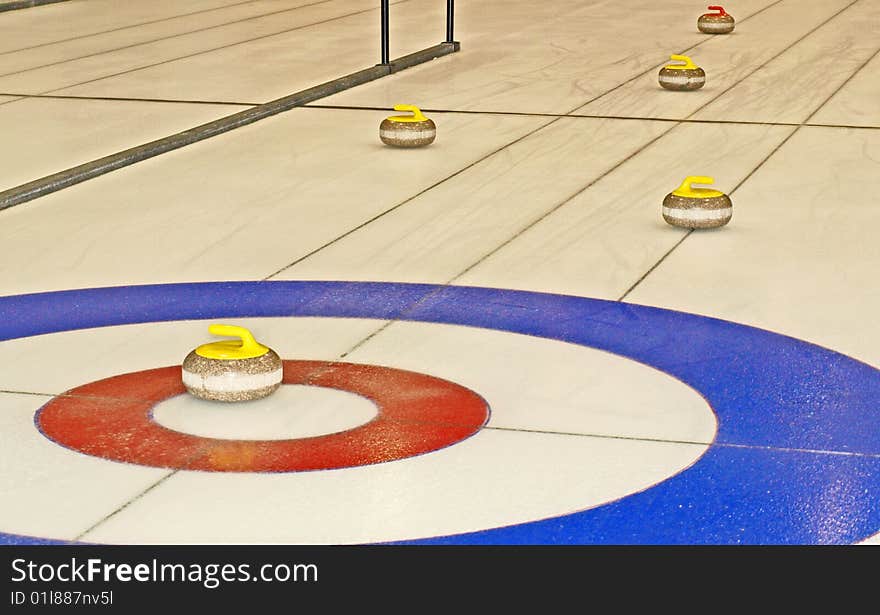 This curling rock is right in the house and well guarded in this game.