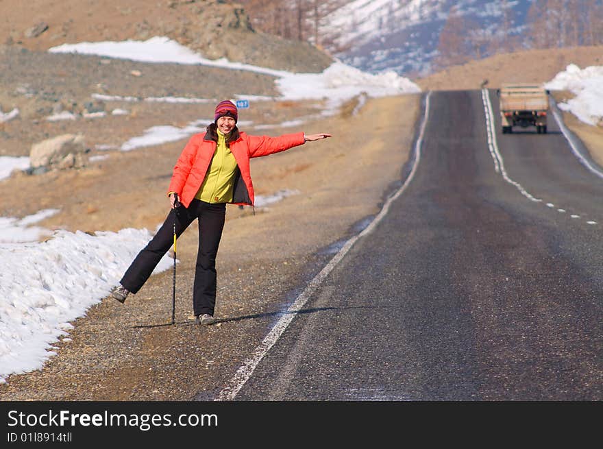 Young woman waiwing for lift on the roadside. Young woman waiwing for lift on the roadside