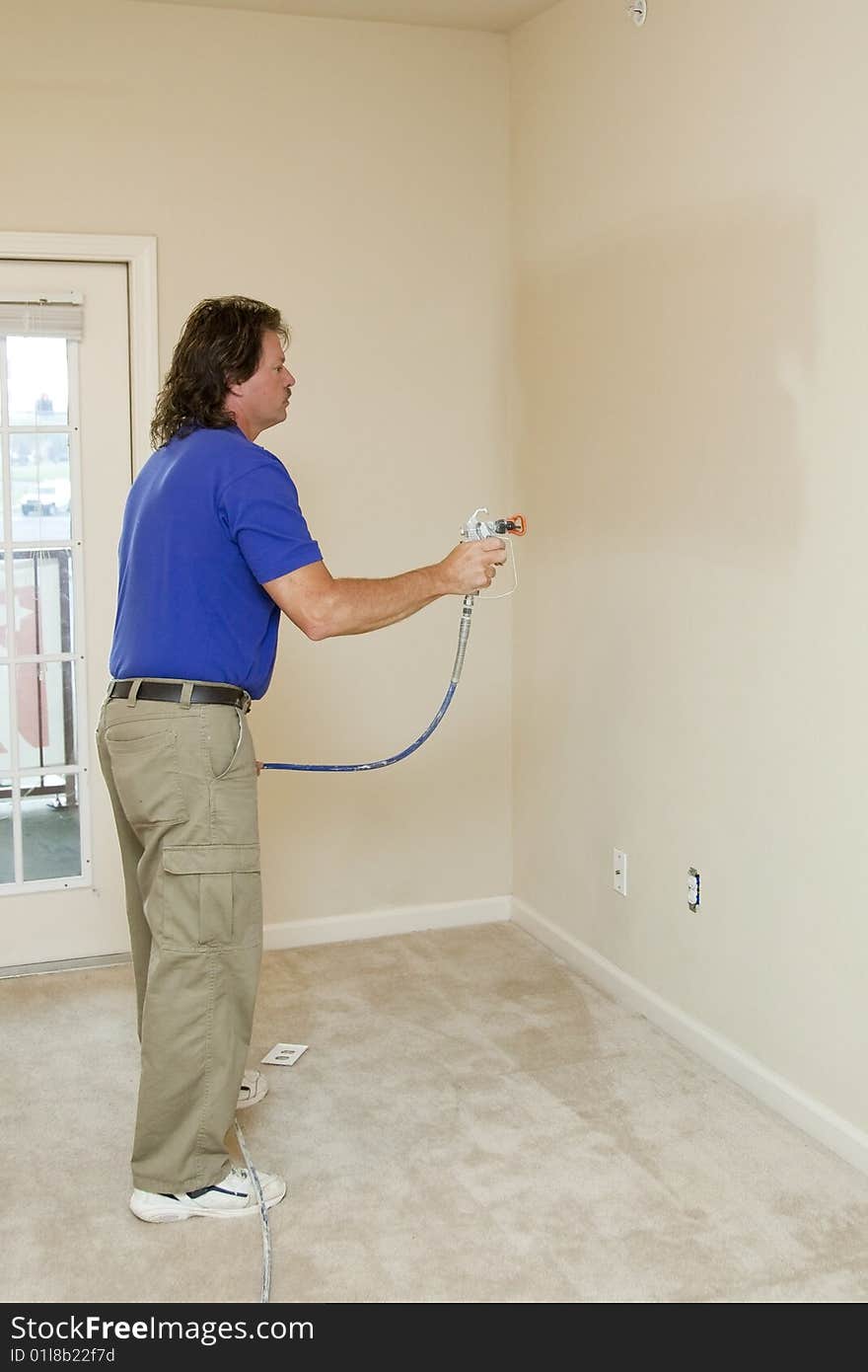 Contract painter updating colors of walls to speed up selling of home. Contract painter updating colors of walls to speed up selling of home