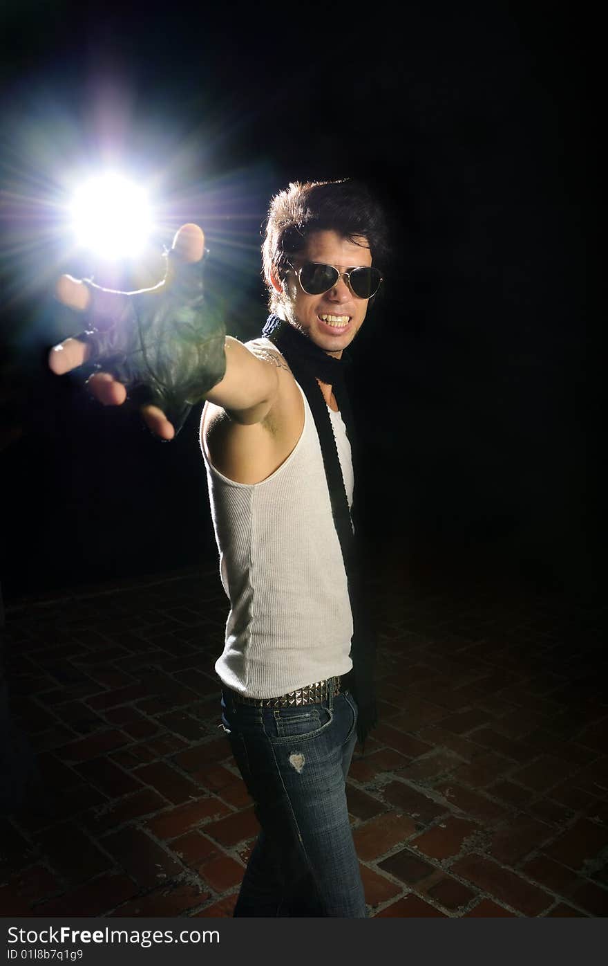 Portrait of young trendy male model holding light flare. Portrait of young trendy male model holding light flare