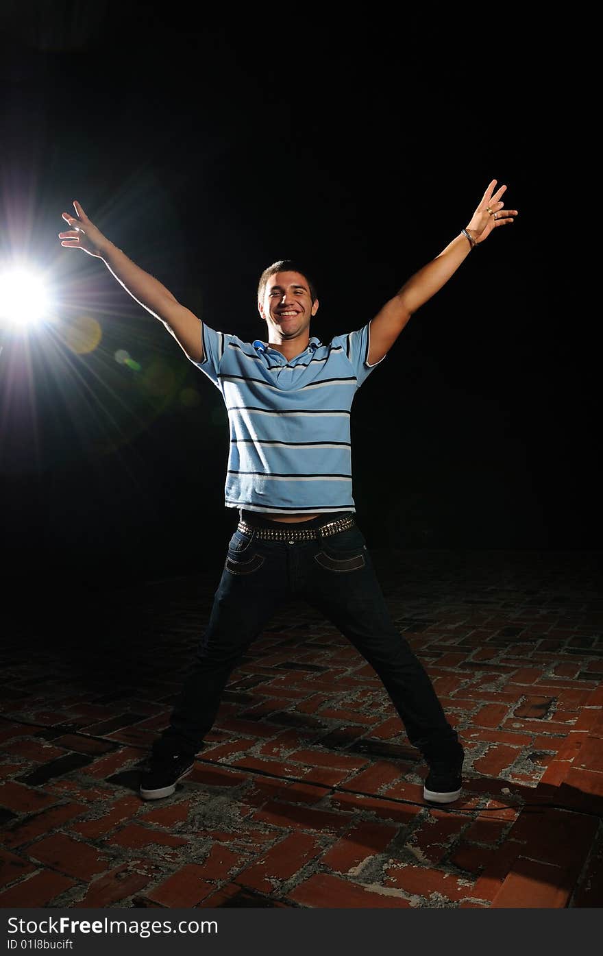 Portrait of young happy man with raised arms. Portrait of young happy man with raised arms