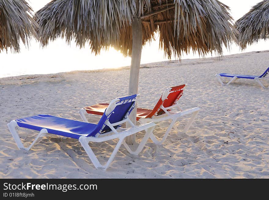 Beach chairs on tropical cuban beach at sunset. Beach chairs on tropical cuban beach at sunset