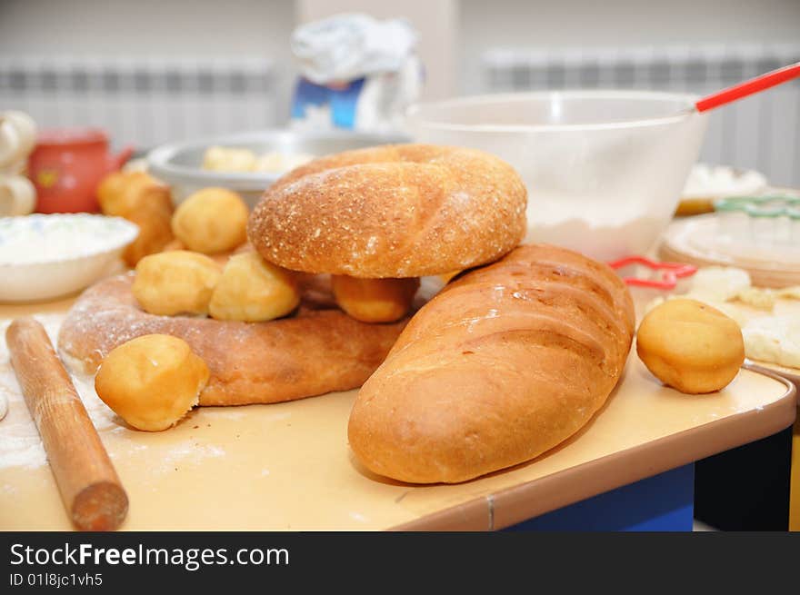 Fresh-baked bread and dough on the table