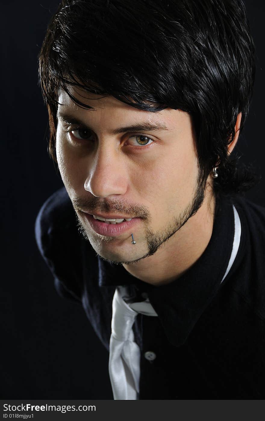 Portrait of young hispanic businessman over black background. Portrait of young hispanic businessman over black background